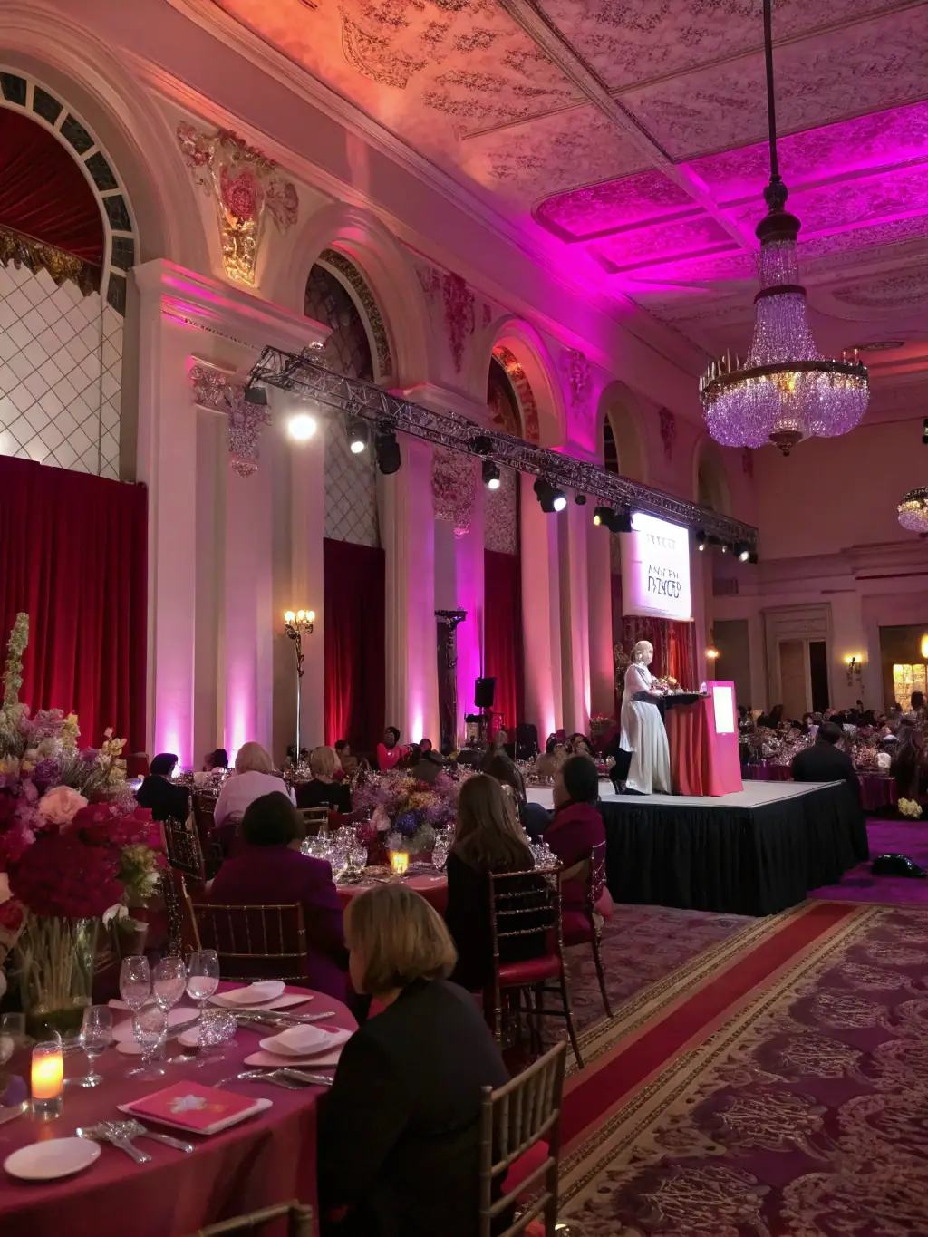 A photograph of a fundraising gala event held in a historic castle, with attendees dressed in formal attire, supporting the preservation efforts of FONDS DE DOTATION AMBITION EUROMED.